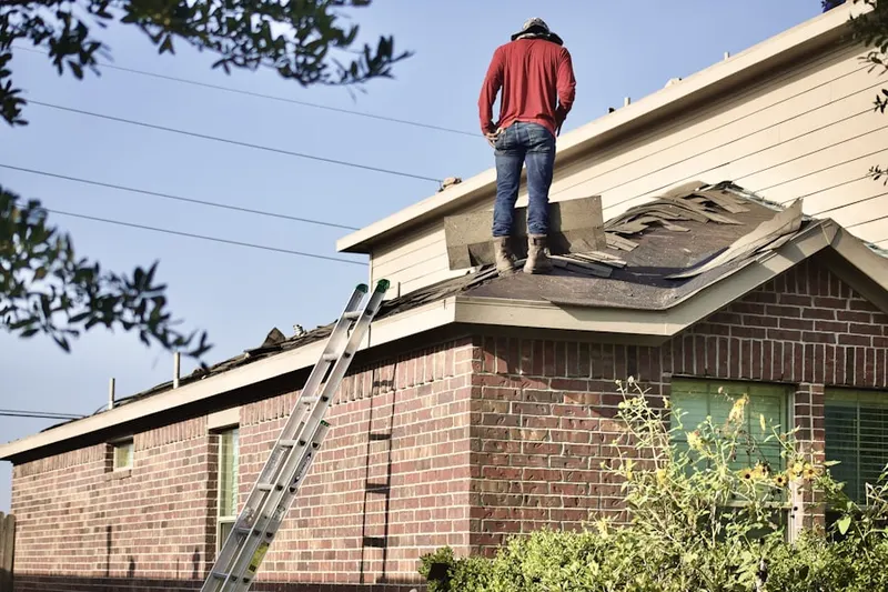 Professional roofer working on a residential roof in Sheboygan